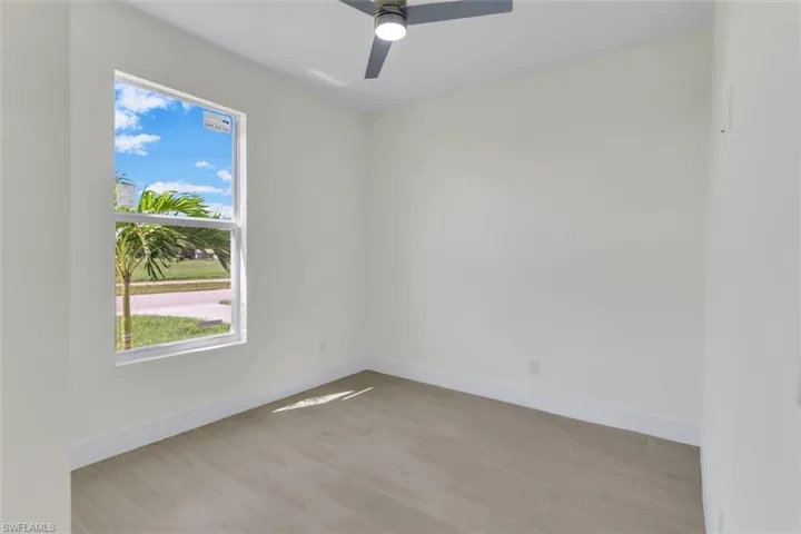 Unfurnished room featuring light wood-style flooring and a ceiling fan