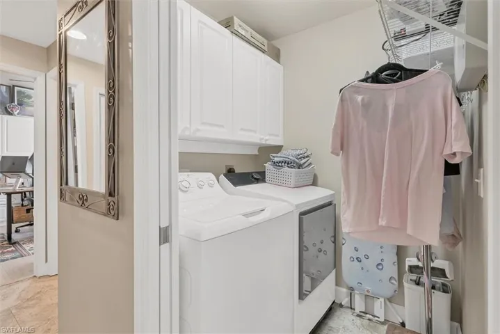 Laundry room featuring cabinet space and independent washer and dryer