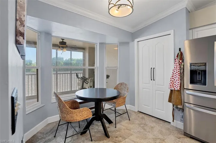 Dining space featuring ornamental molding, baseboards, and a ceiling fan