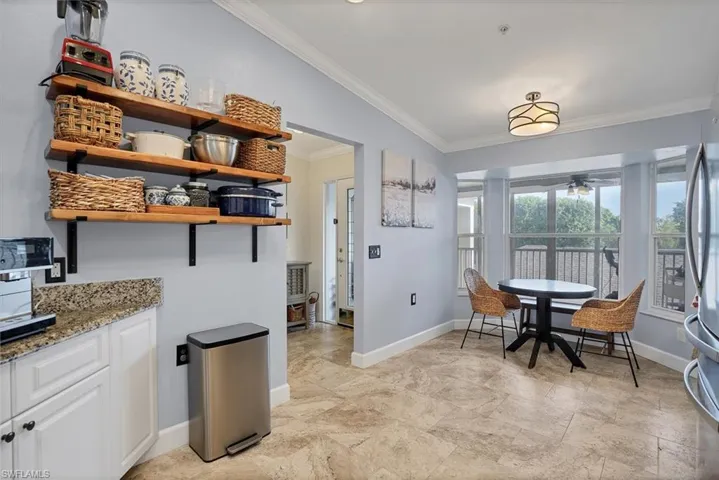 Dining space featuring crown molding, baseboards, and a ceiling fan