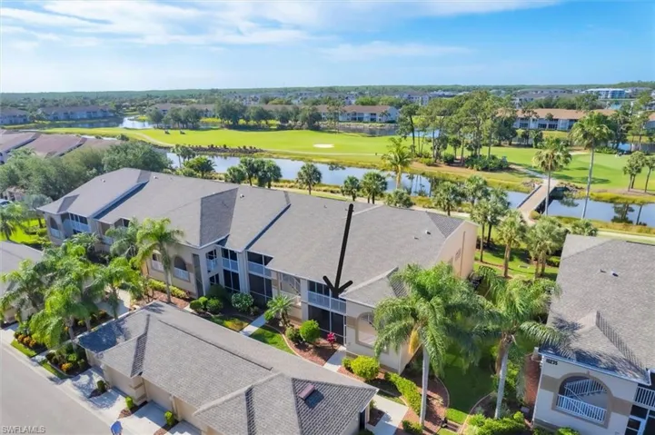 Drone / aerial view with a residential view, view of golf course, and a water view