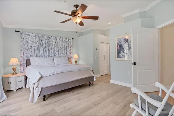 Bedroom with ornamental molding, light wood-style floors, baseboards, ceiling fan, and recessed lighting