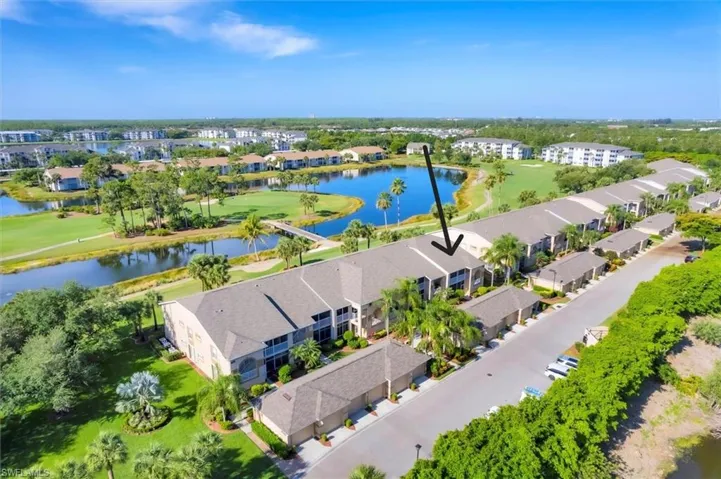 Birds eye view of property with a water view and golf course view