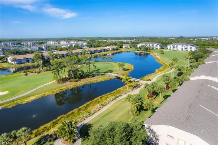 Birds eye view of property featuring a water view and golf course view