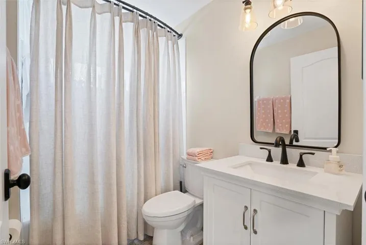 Bathroom featuring vanity and toilet