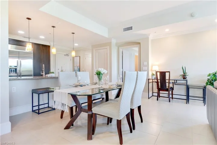 Dining room featuring crown molding, recessed lighting, and light tile patterned flooring