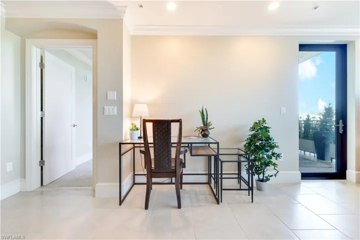 Office area with ornamental molding, light tile patterned floors, recessed lighting, and arched walkways