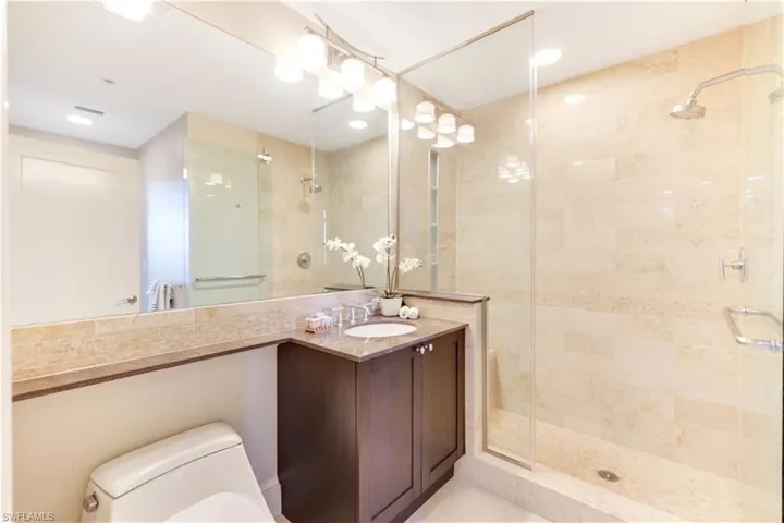 Bathroom featuring a shower stall and vanity