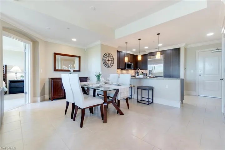 Dining area featuring ornamental molding, recessed lighting, and light tile patterned flooring