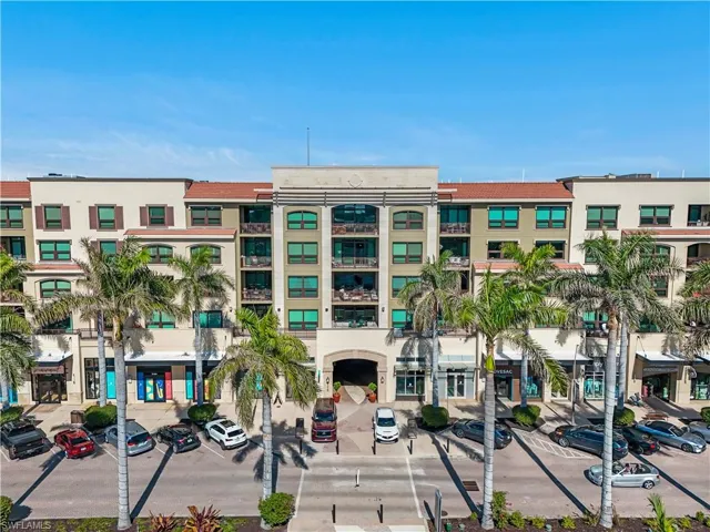 View of property featuring uncovered parking