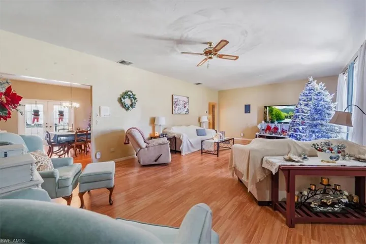 Bedroom with hardwood / wood-style floors and french doors
