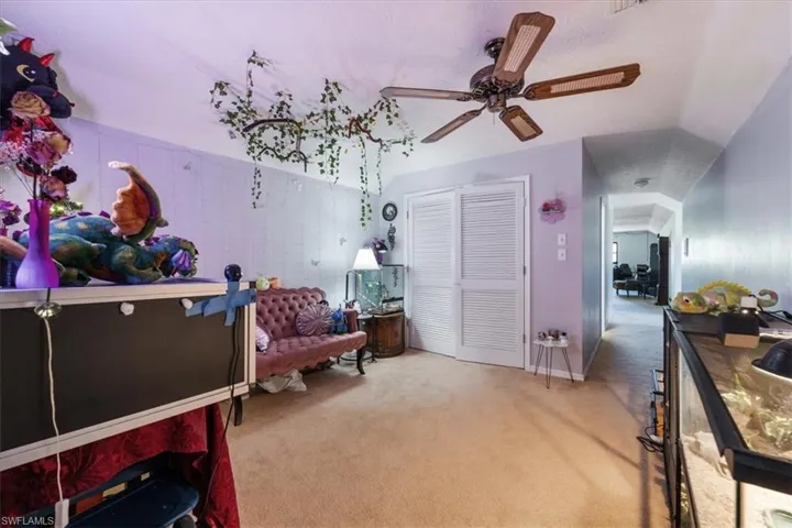Bedroom featuring carpet flooring and vaulted ceiling