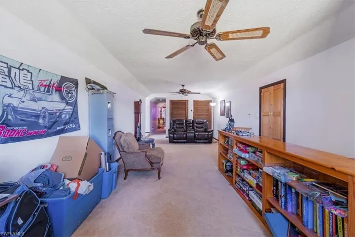 Sitting room with carpet floors and a textured ceiling