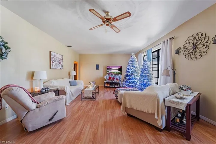 Living room with hardwood / wood-style flooring and ceiling fan