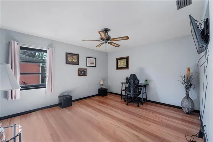 Unfurnished office featuring light wood-type flooring and ceiling fan
