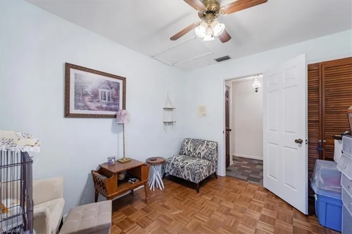 Living area featuring ceiling fan and light parquet floors