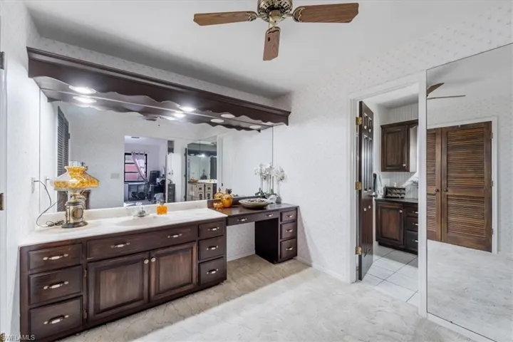 Bathroom with ceiling fan and vanity
