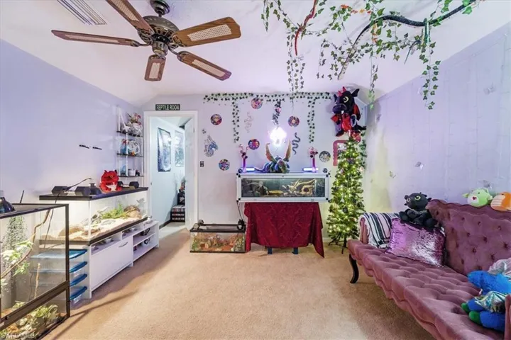 Rec room featuring carpet flooring, vaulted ceiling, and ceiling fan