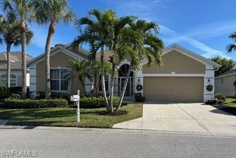 Single story home featuring a front lawn, concrete driveway, stucco siding, and a garage