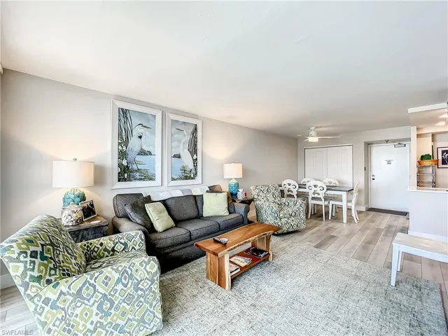 Living room featuring wood tiled floors and ceiling fan