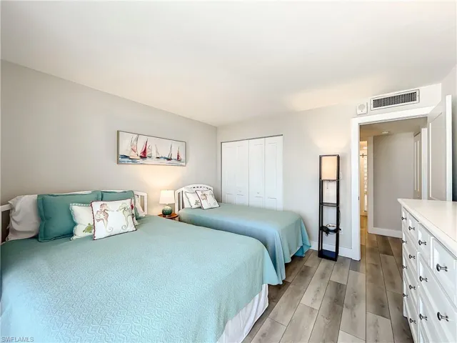 Bedroom featuring wood tiled floors and a closet