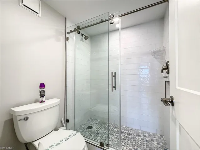Bathroom with a stall shower and toilet