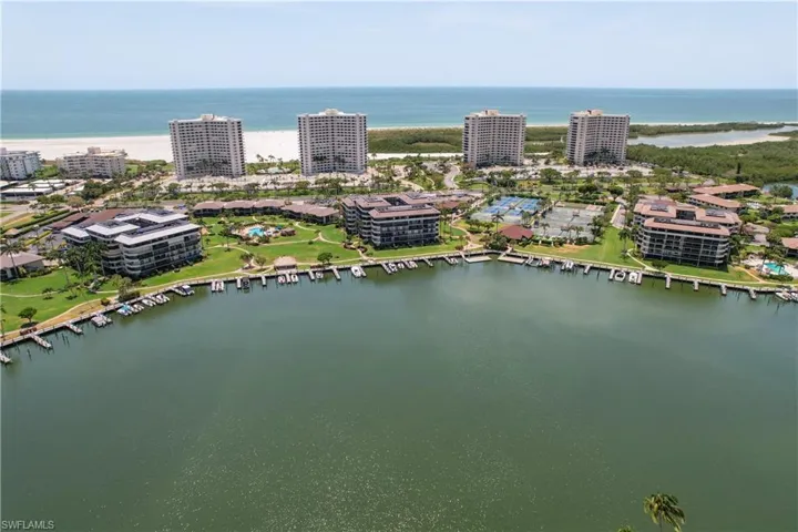 View of urban area with a large body of water and a marina