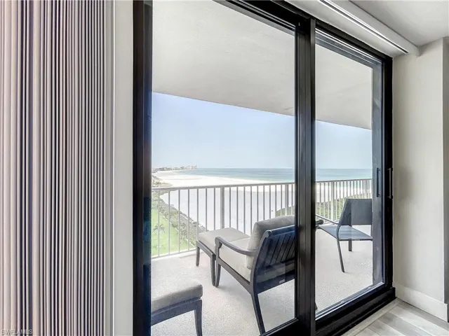 Balcony featuring view of water and beach