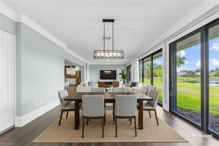 Dining area with wood-finish flooring, crown molding, and a modern rectangular chandelier