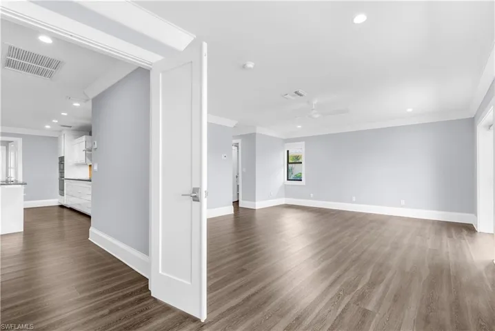 Spacious interior featuring wood-finish flooring, recessed lighting, and a modern ceiling fan