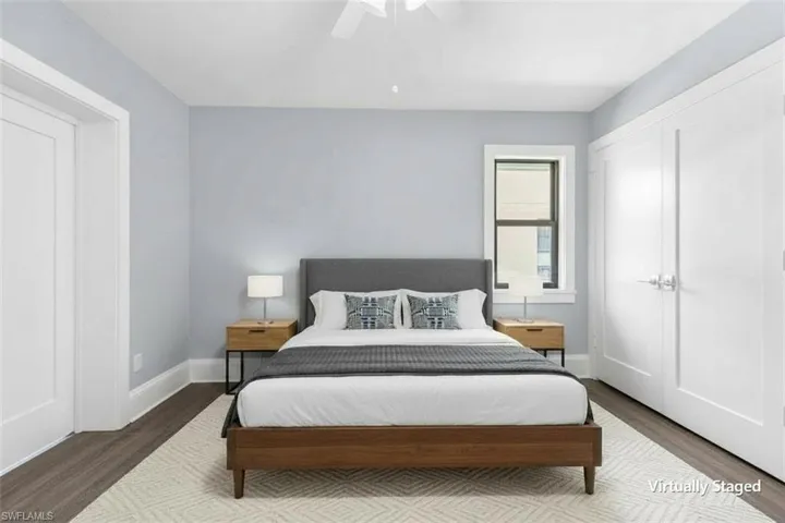 Light blue walls and dark wood-finish flooring with white trim