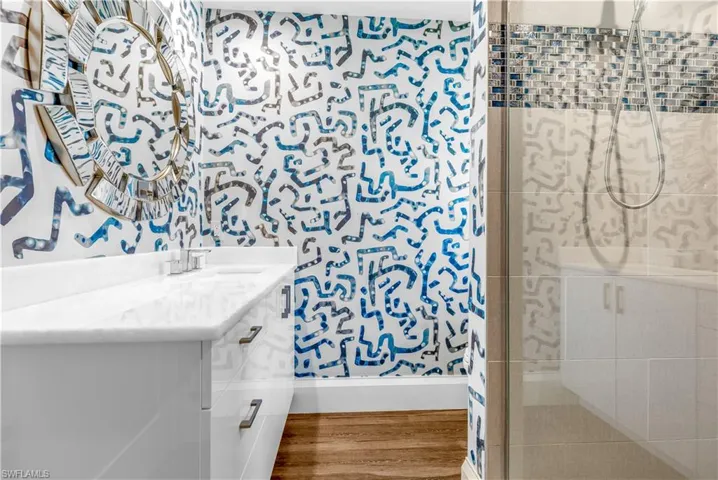 Bathroom featuring a white vanity with a rectangular basin sink, chrome faucet, and integrated countertop