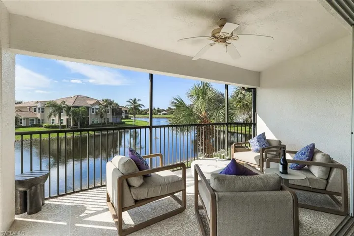 Sunroom / solarium with a water view and ceiling fan