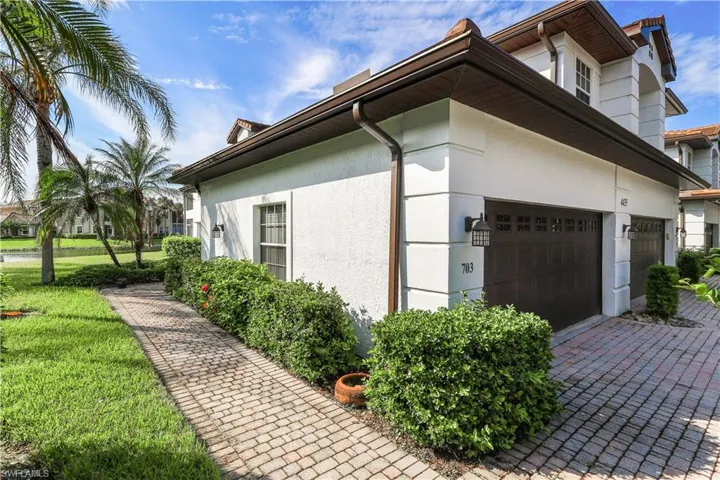 View of property exterior featuring a yard and a garage