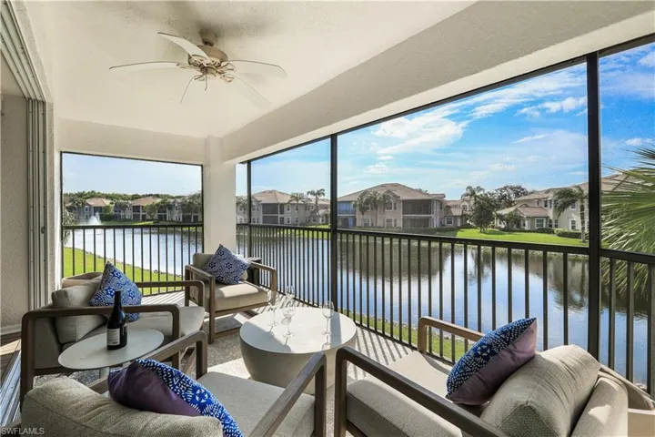 Sunroom featuring a water view and ceiling fan