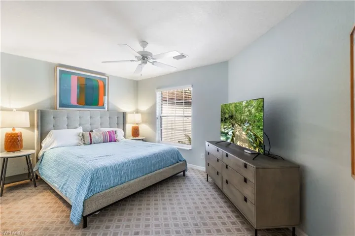 Bedroom featuring ceiling fan and light carpet