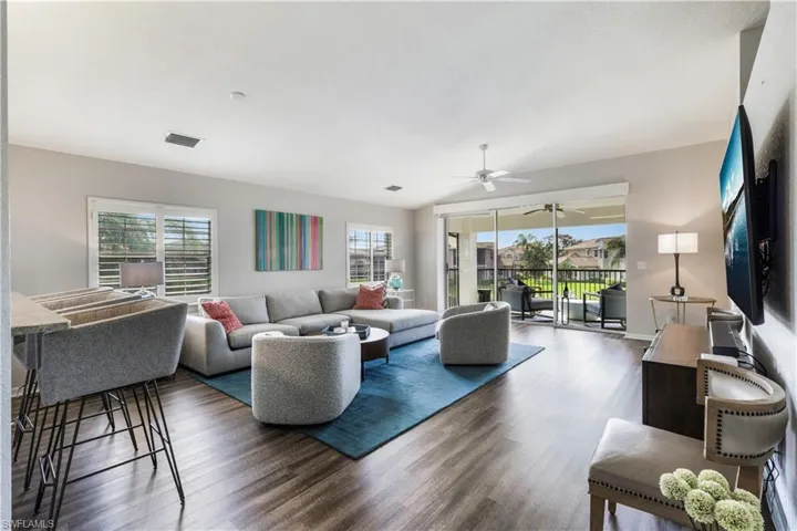 Living room featuring ceiling fan and dark hardwood / wood-style flooring