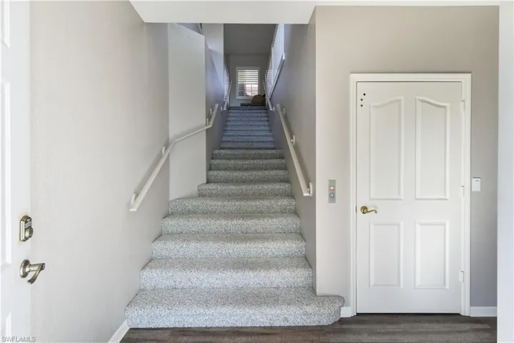 Stairs featuring wood-type flooring