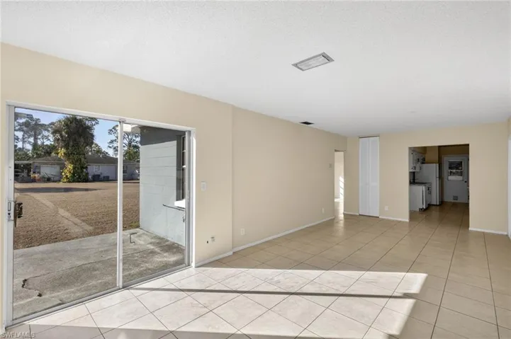 Spare room featuring light tile patterned floors and a textured ceiling