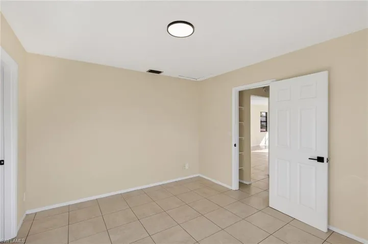 Unfurnished room featuring baseboards and light tile patterned floors