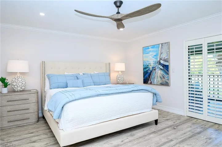 Bedroom featuring ceiling fan, ornamental molding, and hardwood / wood-style flooring