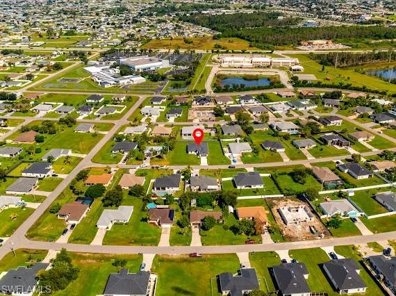 Birds eye view of property with a water view
