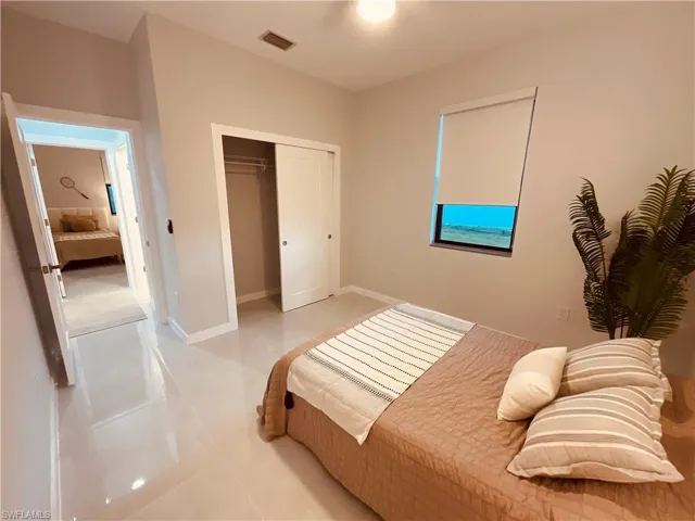 Bedroom featuring a closet and light tile patterned flooring