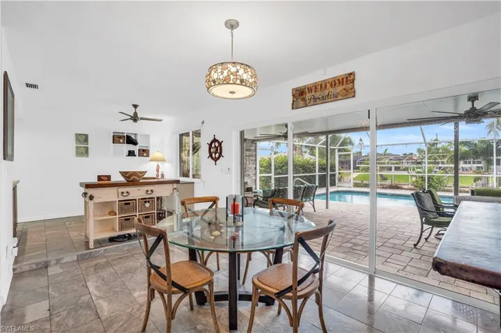 Dining space with a ceiling fan, visible vents, and baseboards