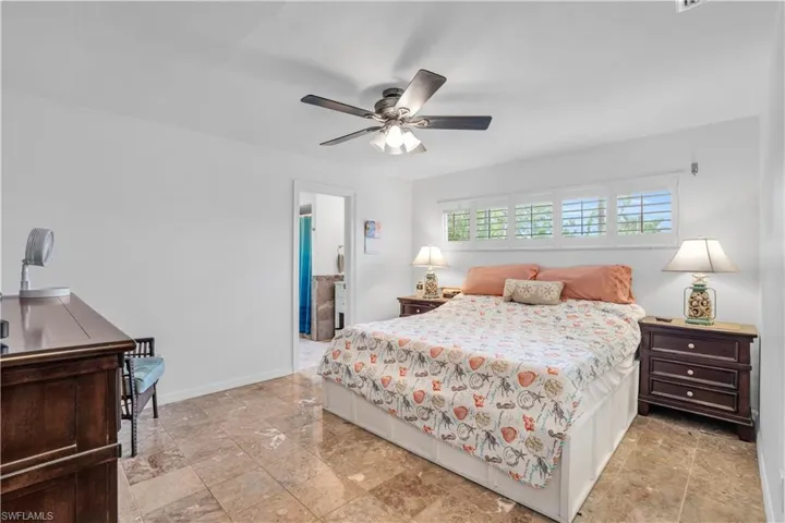 Bedroom featuring a ceiling fan and baseboards