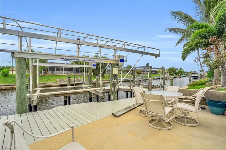 Dock area featuring a water view and boat lift