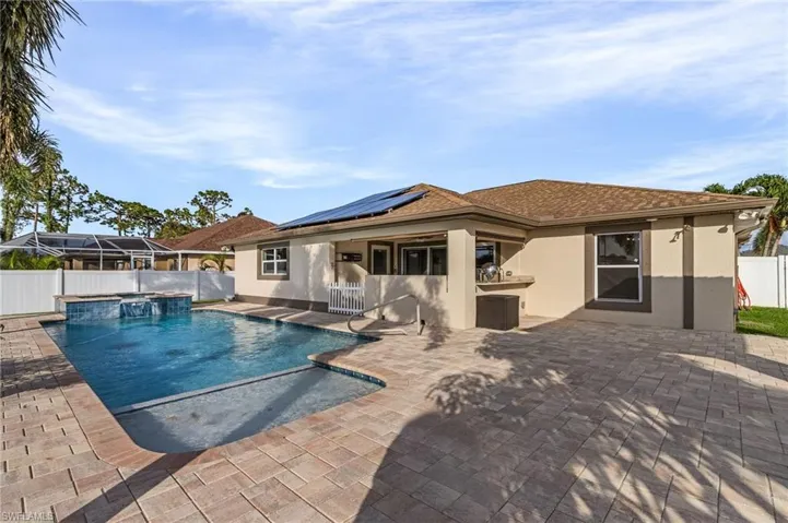 View of swimming pool with a lanai, pool water feature, and a patio area