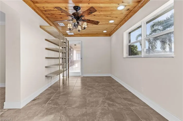 Unfurnished room with wooden ceiling and ceiling fan