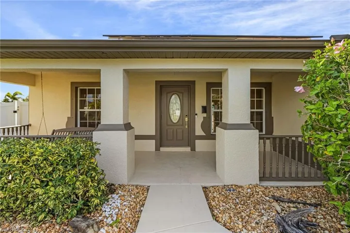 View of exterior entry with a porch