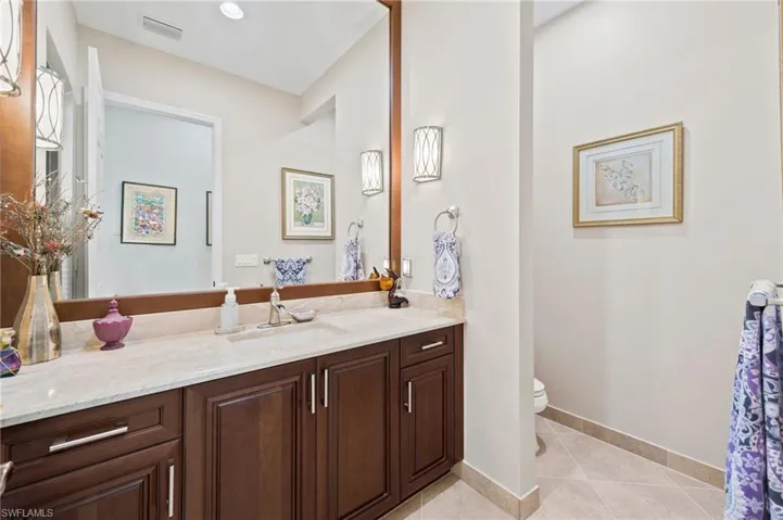 Bathroom featuring tile patterned floors, vanity, and toilet
